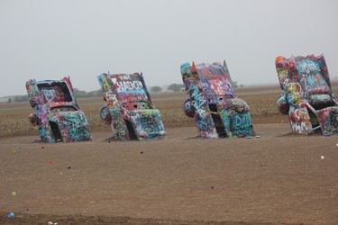 Visitors to Cadillac Ranch can bring their own spraypaint and leave a message for the next visitors, just as Sara Shantz did. IAN SHANTZ/TORONTO SUN