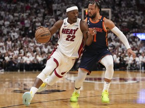 Jimmy Butler, left, of the Miami Heat drives past Jalen Brunson of the New York Knicks during game three of the Eastern Conference Semifinals at Kaseya Center on May 6, 2023 in Miami, Fla.