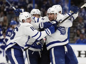 Toronto Maple Leafs center John Tavares celebrates with right wing Mitchell Marner after Tavares scored the game-winning goal against the Tampa Bay Lightning during overtime in Game 6 of an NHL hockey Stanley Cup first-round playoff series Saturday, April 29, 2023, in Tampa, Fla.