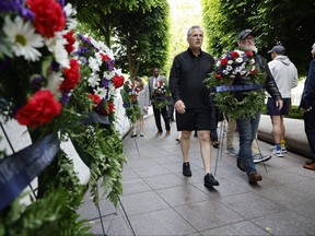 Speaker of the House Kevin McCarthy (R-CA), left, joins Rep. Derrick Van Orden (R-WI) as they lay a wreath in honour of U.S. Border Patrol Agent Raul Gonzalez at The National Law Enforcement Officers Memorial on May 11, 2023 in Washington, D.C.