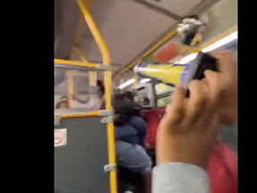 A screengrab from video of a person with fireworks on a TTC bus.