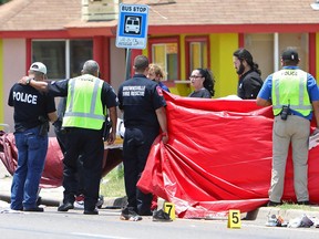 A police officer is consoled after a deadly incident where a car ran into pedestrians near Ozanam Center, a shelter for migrants and homeless, in Brownsville, Texas, U.S. May 7, 2023.