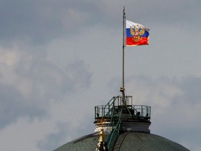 The Russian flag flies on the dome of the Kremlin Senate building, while the roof shows what appears to be marks from the recent drone incident, in central Moscow, Russia, May 4, 2023.