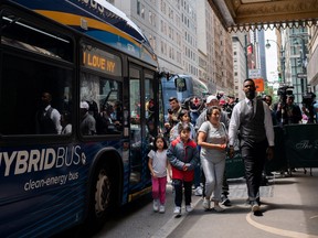 A family of asylum-seekers arrives at the Roosevelt Hotel where migrants are currently being housed in New York City, May 19, 2023.