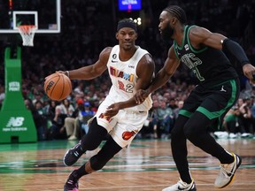 Dec 2, 2022; Boston, Massachusetts, USA; Miami Heat forward Jimmy Butler (22) controls the ball while Boston Celtics guard Jaylen Brown (7) defends during the first half at TD Garden.