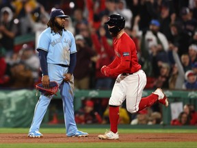 Red Sox’s Connor Wong celebrates in front of Blue Jays’ Vlad Guerrero Jr. after hitting a home run in Boston last night.