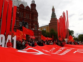 Members and supporters of the Russian Communist Party hold a large copy of the Soviet Banner of Victory in front of a monument to Soviet World War Two commander Marshal Georgy Zhukov on the eve of Victory Day, marking the anniversary of the victory over Nazi Germany in World War Two, in Moscow, Russia May 8, 2023.