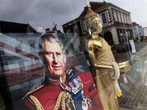 A portrait of King Charles III displayed in the front window of a Thai beauty salon before the coronation ceremony on May 6, 2023.