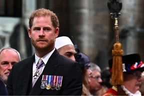 Prince Harry, Duke of Sussex looks on as King Charles III leaves Westminster Abbey after the Coronation Ceremonies in central London on May 6, 2023.