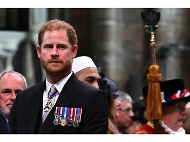 Prince Harry, Duke of Sussex looks on as King Charles III leaves Westminster Abbey after the Coronation Ceremonies in central London on May 6, 2023.