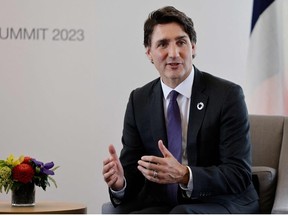 Canada's Prime Minister Justin Trudeau takes part in a bilateral meeting with France's President Emmanuel Macron on the sidelines of the G7 Leaders' Summit in Hiroshima on May 19, 2023.