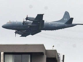 A CP-140 Aurora aircraft is pictured during a flyby over Stanley Park to attend a Battle of Britain commemoration ceremony September 8, 2019 in Vancouver, BC.