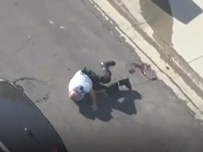 A volunteer police officer falls to the ground after being stung by a bee