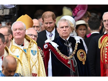 Prince Andrew and Prince Harry look on as they leave Westminster Abbey following the coronation ceremony of King Charles and Queen Camilla, in London, May 6, 2023.