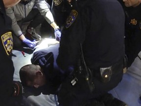 In this image from a nearly 18-minute video taken by a California Highway Patrol sergeant, Edward Bronstein, 38, is taken into custody by CHP officers on March 31, 2020, following a traffic stop in Los Angeles.