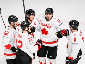 Canadian forward Milan Lucic celebrates with teammates during a win over Slovenia in Riga, Latvia, on May 14, 2023.
