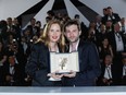 Justine Triet and Arthur Harari pose with The Palme D'Or Award
