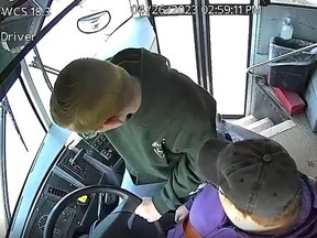 This frame, taken from surveillance video of a school bus, shows middle school student Dillon Reeves slamming on the brakes and pulling his school bus out of traffic after the driver passed out on April 26.