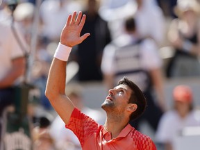 Serbia's Novak Djokovic celebrates after winning the first round match of the French Open tennis tournament against Aleksandar Kovacevic of the U.S. in three sets, 6-3, 6-2, 7-6 (7), at the Roland Garros stadium in Paris, Monday, May 29, 2023.