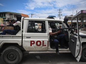 Police officers patrol a neighbourhood amid gang-related violence in downtown Port-au-Prince on April 25, 2023.