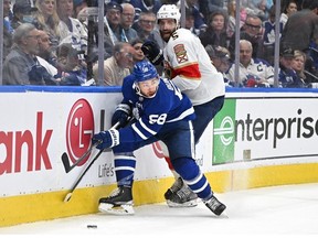 May 2, 2023; Toronto, Ontario, CANADA;  Toronto Maple Leafs forward Michael Bunting and Florida Panthers forward Aaron Ekblad battle for the puck in the first  period in game one of the second round of the 2023 Stanley Cup Playoffs at Scotiabank Arena.
