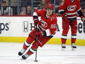 FILE - Carolina Hurricanes' Teuvo Teravainen skates with the puck during the second period of Game 2 in the team's NHL hockey Stanley Cup first-round playoff series against the New York Islanders in Raleigh, N.C., April 19, 2023. Teravainen's roughly month-long absence due to injury could be nearing an end. The Carolina Hurricanes forward has shed his no-contact jersey and participated in a full practice Monday, May 15, ahead of the Eastern Conference final against Florida. Teravainen hasn't played since he suffered a thumb injury early in the first-round series.