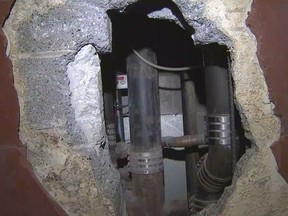 Hole in Georgia jail shower stall dug out by inmate.