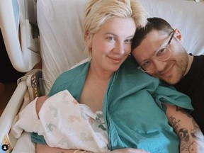 Ireland Baldwin and RAC are pictured with their newborn in a photo posted on Baldwin's Instagram account.