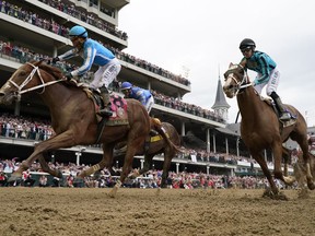 Javier Castellano celebrates after riding Mage to win the 149th running of the Kentucky Derby horse race at Churchill Downs Saturday, May 6, 2023, in Louisville, Ky.