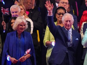 Queen Camilla and King Charles III react as they attend the Coronation Concert at Windsor Castle in Windsor, west of London on May 7, 2023.