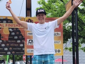 Trans cyclist Lesley Mumford stands alone on podium.
