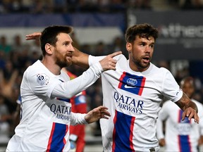 Paris Saint-Germain's Argentine forward Lionel Messi celebrates scoring his team's first goal next to Paris Saint-Germain's Spanish defender Juan Bernat