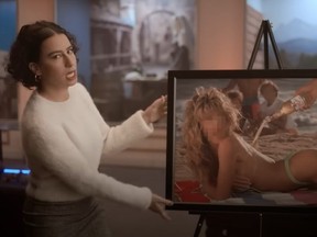 Screenshot of Ilana Glazer holding framed photo of woman in bikini in Miller Lite ad.