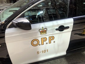 An Ontario Provincial Police vehicle sits idle in downtown Toronto, Tuesday, April 11, 2023.