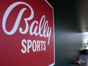 FILE - A Bally Sports logo is on a dugout wall during a spring training baseball game at Roger Dean Stadium, March 4, 2023, in Jupiter, Fla. Major League Baseball will take over broadcasts of San Diego Padres games beginning Wednesday, May 31.