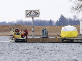 Searchers dock at a marina as the search for victims continues Friday, March 31, 2023, after a boat capsized and left eight people dead in Akwesasne, Que.