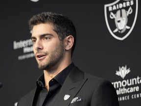 FILE - Las Vegas Raiders quarterback Jimmy Garoppolo takes questions during an NFL football news conference, Friday, March 17, 2023, in Henderson, Nev. The new Raiders quarterback is not taking part in organized team activities because of a lingering foot injury. Coach Josh McDaniels said Thursday, May 25, 2023, that Garoppolo could be held out until July when training camp begins.