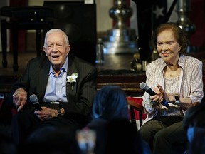 Former U.S. president Jimmy Carter and his wife former first lady Rosalynn Carter sit together
