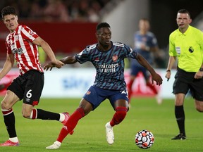 FILE - Brentford's Christian Norgaard vies for the ball with Arsenal's Folarin Balogun, center, during the English Premier League soccer match between Brentford and Arsenal at the Brentford Community Stadium in London, on Aug. 13, 2021. The United States can select Balogun after the England Under-21 forward who has starred in the French league opted to represent the 2026 World Cup co-host. FIFA said on Tuesday May 16, 2023 it approved a request by the U.S. Soccer Federation to change Balogun's national eligibility from England. The 21-year-old New York-born player also was eligible for Nigeria.