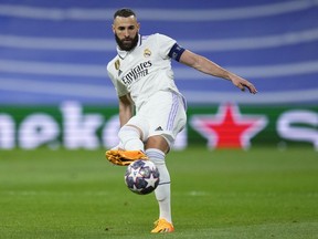 Real Madrid's Karim Benzema passes the ball during the Champions League semifinal first leg soccer match between Real Madrid and Manchester City at the Santiago Bernabeu stadium in Madrid, Spain, Tuesday, May 9, 2023.