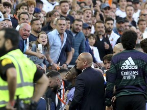Real Madrid's Vinicius Junior, lower centre, reacts towards Valencia fans after being sent off during a Spanish La Liga soccer match between Valencia and Real Madrid, at the Mestalla stadium in Valencia, Spain, Sunday, May 21, 2023. The game was temporarily stopped when Vinicius said a fan had insulted him from the stands. He was later sent off after clashing with Valencia players.