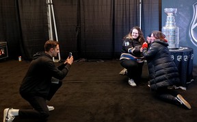 Fans pose for a photo with the Stanley Cup before the Stadium Series game in Raleigh, N.C. (Dave Pollard/Toronto Sun)