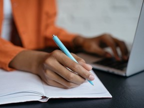A student writes in a notebook.