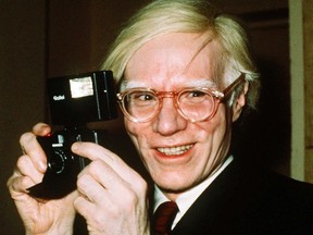 artist Andy Warhol smiles in New York