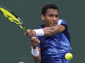 Felix Auger-Aliassime, of Canada, returns to Pedro Martinez, of Spain, at the BNP Paribas Open tennis tournament Saturday, March 11, 2023, in Indian Wells, Calif.