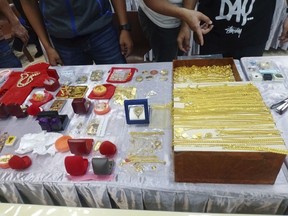 In this handout photo released by Thai police Central Investigation Bureau and taken Wednesday, May 10, 2023, Thai police display gold and other jewelry they discovered in a raid on a Buddhist temple at police station in Nakhon Ratchasima, northeast of Thailand.