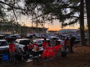 Fans tailgate among the pines outside Carter-Finley Stadium before the Stadium Series NHL game in Raleigh, N.C.