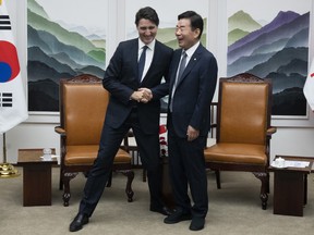 Prime Minister Justin Trudeau jokes with South Korea's National Assembly Speaker Kim Jin-pyo as they pose for a photo ahead of a bilateral meeting in Seoul on Wednesday, May 17, 2023.