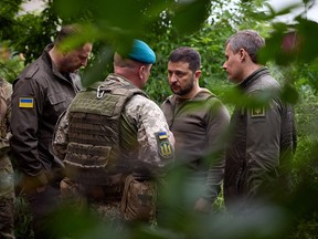 Ukrainian President Volodymyr Zelensky talks with officers during his visit to the forward positions of the Armed Forces of Ukraine in the Vugledar-Maryinka defense zone, Donetsk region.