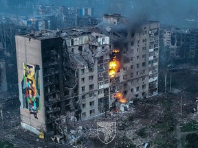 This undated handout aerial footage released on May 21, 2023 shows an apartment block on fire in the city of Bakhmut, Donetsk.